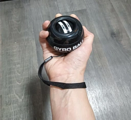 Эспандер кистевой гироскопический гиробол павербол Powerball Gyroball тренажер для кисти запястья предплечья сила хвата антистресс реабилитации после травм координации выносливости вращающийся шар нескользящий корпус спортивный черный фото от покупателей 3