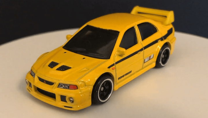 Тематическая Машинка Hot Wheels Mitsubishi Mitsubishi Lancer Evolution VI '90s Street Scene 1:64 JCB58 GDG44 Yellow - изображение 2