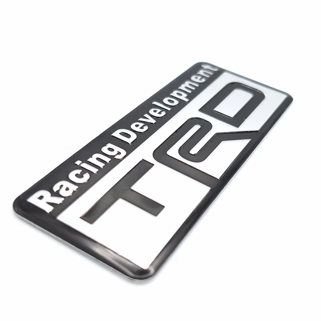 Эмблема алюминиевая Racing Development TRD Toyota (чёрный+хром) 8,0*3,0 см - Фото 2 Эмблема алюминиевая Racing Development TRD Toyota (чёрный+хром) 8,0*3,0 см - изображение 2