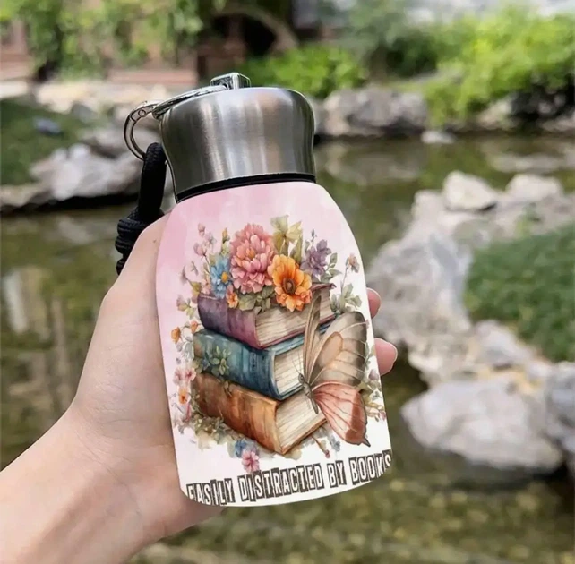 Термобанка 350 мл "Easily Distracted by Books" с карабином, 7.5×15 см, розовая с книгами и бабочками - Фото 1 Термобанка 350 мл "Easily Distracted by Books" с карабином, 7.5×15 см, розовая с книгами и бабочками - изображение 1