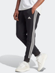 Спортивні штани утеплені чоловічі adidas Fleece 3-Stripes Tapered Cuff IB4030 M Чорні (4066762310050) - зображення 1