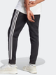 Спортивні штани утеплені чоловічі adidas Fleece 3-Stripes Tapered Cuff IB4030 M Чорні (4066762310050) - зображення 2