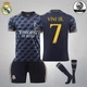 Комплект футбольная детская форма Lion SPORT Real Madrid VINI JN. (ВИнисиус Жуниор) 7, с гетрами (размер 34-38), размер 24 размер, рост 130-140 см, черный с оранжевым - изображение 1