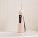 Іригатор для ротової порожнини 200 мл бездротовий акумуляторний Oral Irrigator, портативний з 3 режимами роботи і 4 змінними насадками для догляду за зубами, яснами та брекетами Рожевий, AND-1-37-Pink - зображення 1