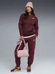 Спортивный костюм женский на флисе Puma 68816096 M Ruby Shimmer (4069157435147) - изображение 1