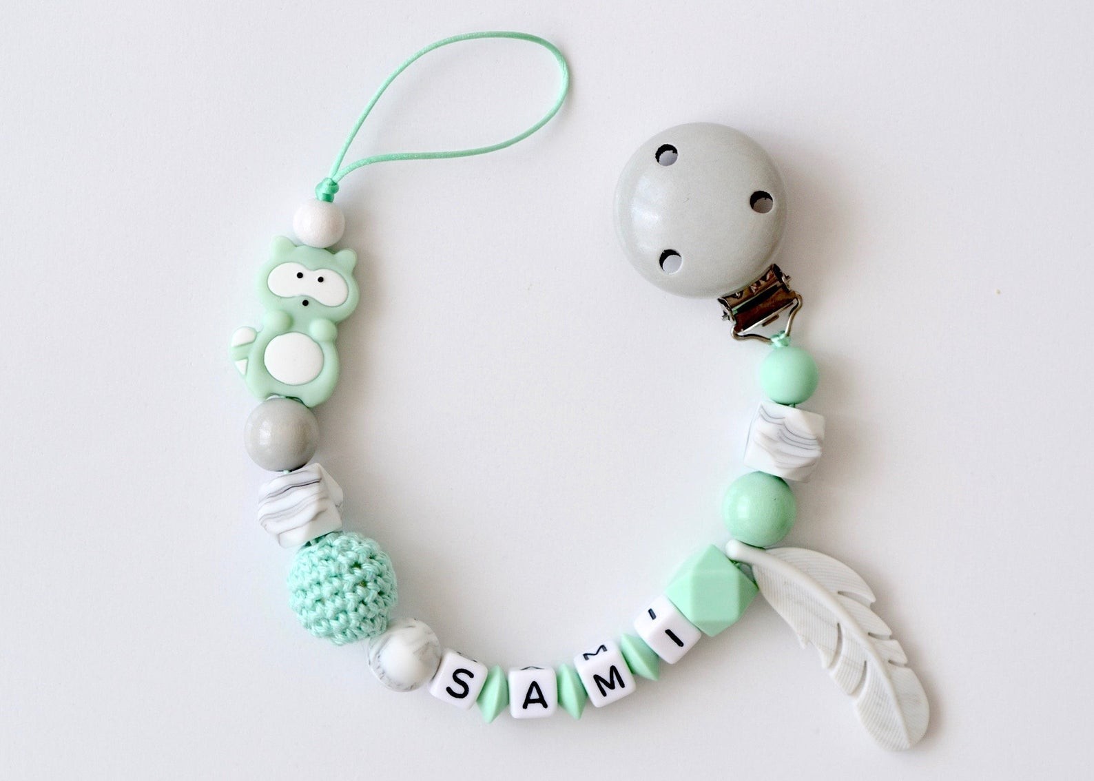 

Прорезыватель - держатель для пустышки Babymall Mint Raccoon