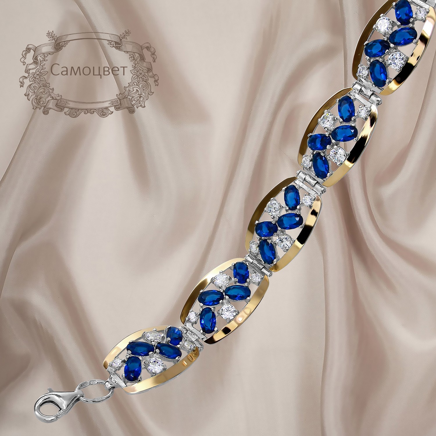 

Красивый женский браслет из серебра 925 пробы с золотыми пластинами 375 пробы и синими фианитами "Самоцвет"